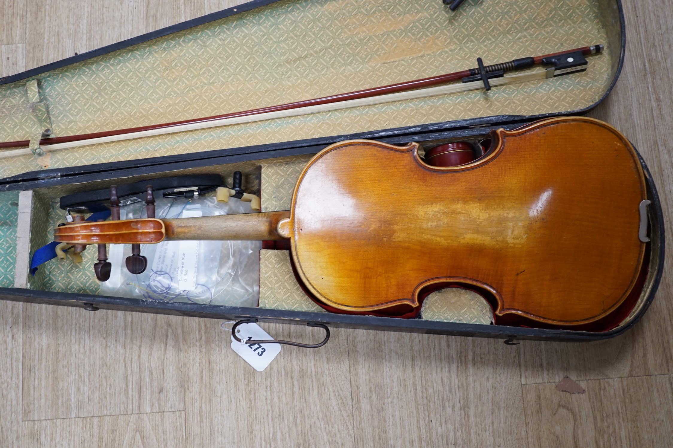 A mid 19th century cased French violin, length of body 35.5cm, with bow, simulated ivory tip